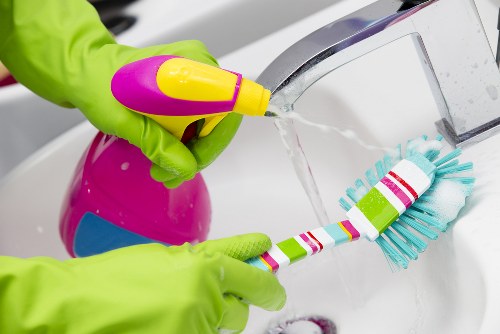 Cleaner recording a customer complaint on a checklist